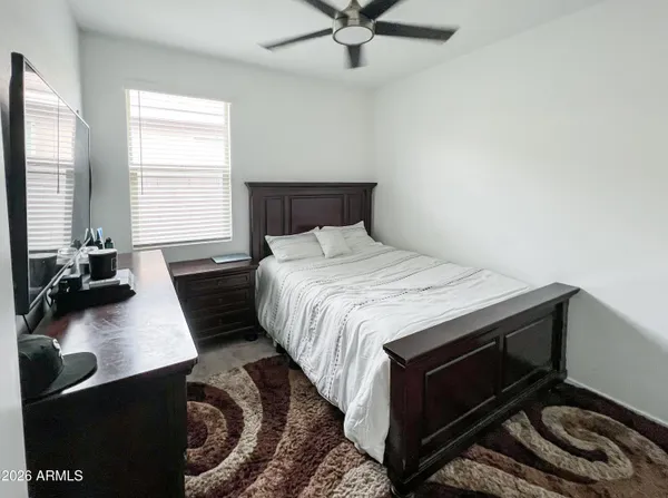 a bedroom with a bed and a dresser