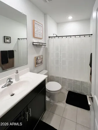 a bathroom with a toilet a sink and shower