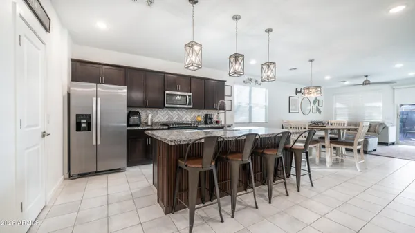 a large kitchen with a table and chairs
