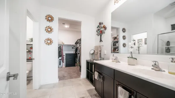 a bathroom with a double vanity sink mirror and shower