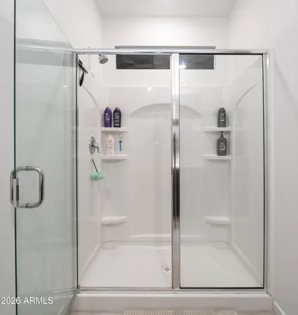 a bathroom with a glass shower door