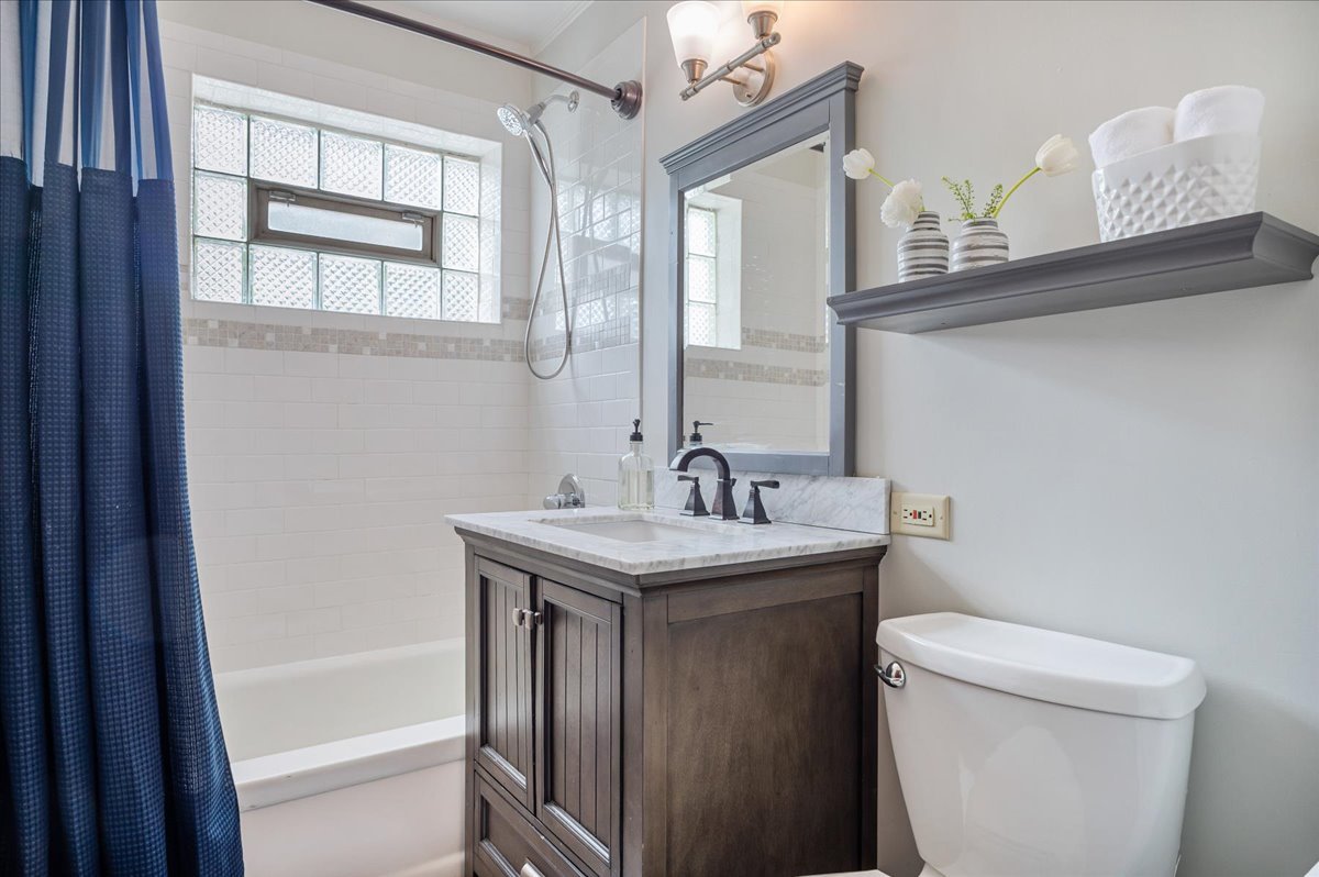 630 Long Road Glenview, IL 60025 - Photo 14 of 24 a bathroom with a granite countertop sink and a toilet