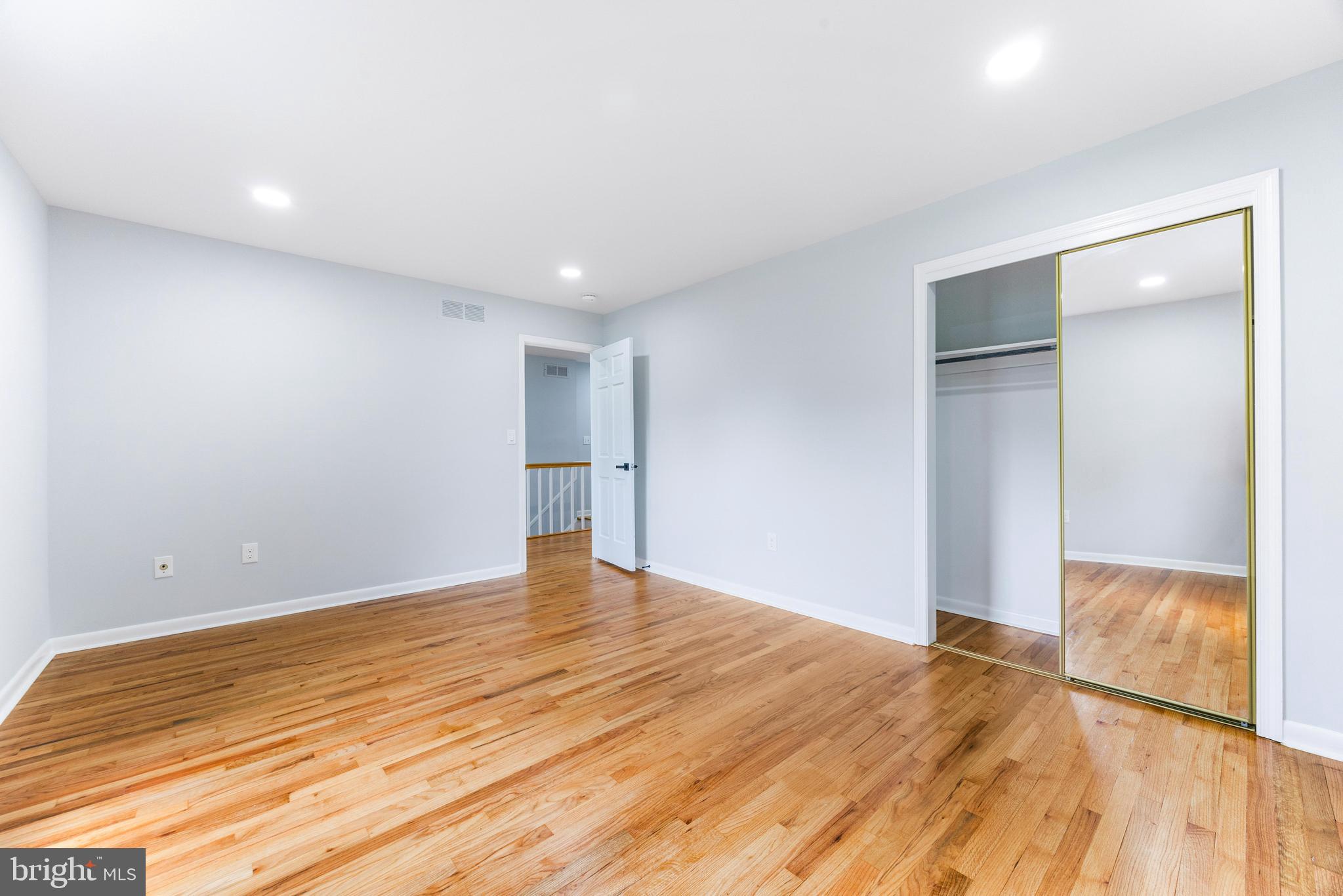1807 Thornton Ridge Road Baltimore, MD 21204 - Photo 31 of 57 a view of an empty room with wooden floor and a window