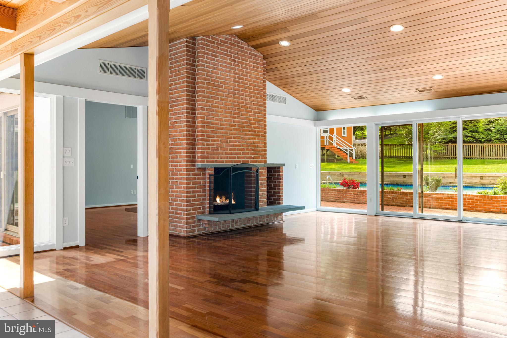 1807 Thornton Ridge Road Baltimore, MD 21204 - Photo 10 of 57 a view of empty room with wooden floor and fireplace