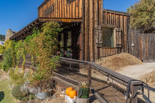 a view of a house with a wooden fence