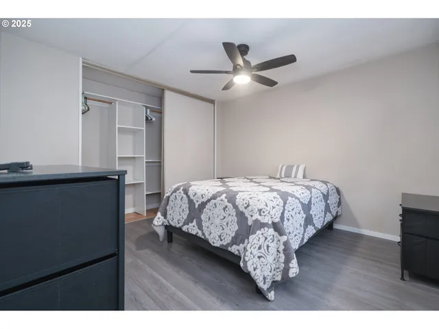 a bedroom with a bed and a ceiling fan