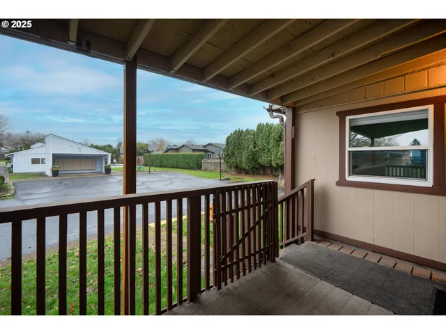 a balcony with wooden floor and outdoor space