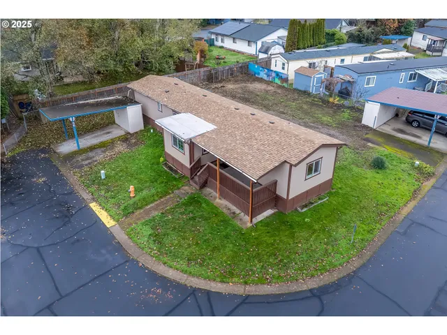 a view of house with backyard and outdoor seating