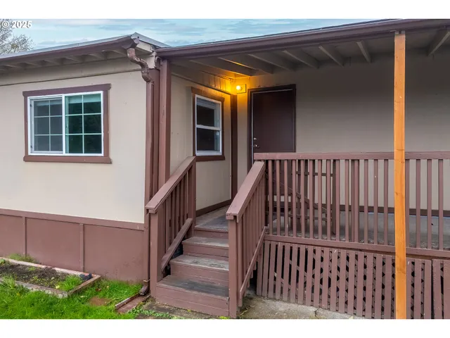 a view of a house with a garden and a table