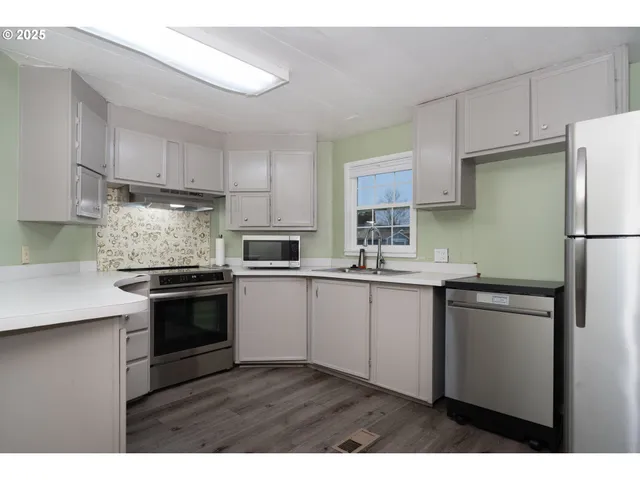 a kitchen with a sink stove and refrigerator