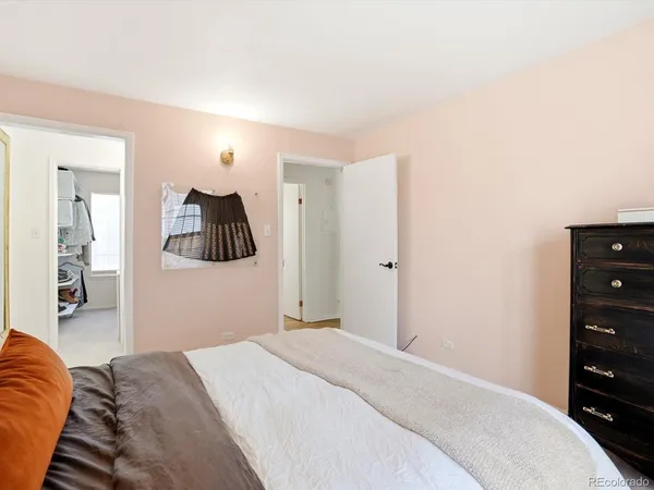 a bedroom with a bed and a dresser