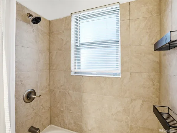 a bathroom with a window and a shower