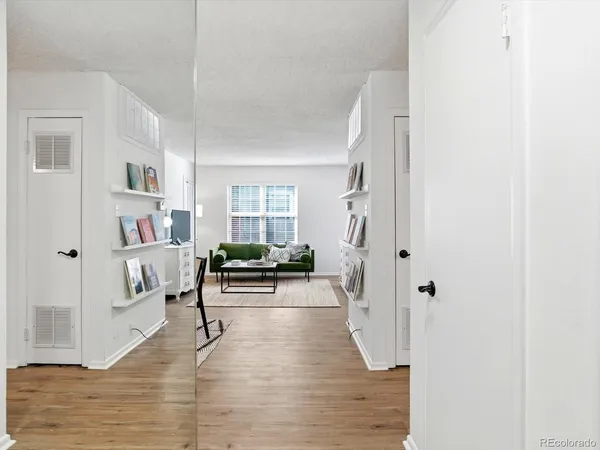 a living room with furniture and a wooden floor