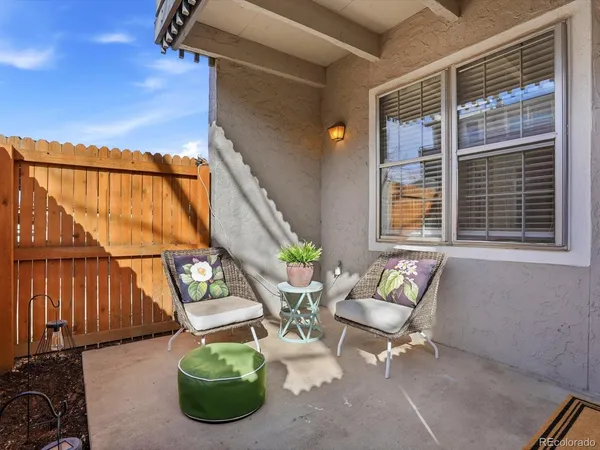 a view of a porch with chairs and a potted plant