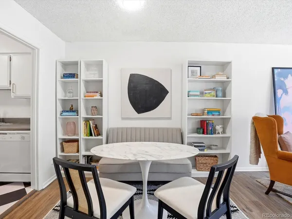 a view of a dining room with furniture and wooden floor