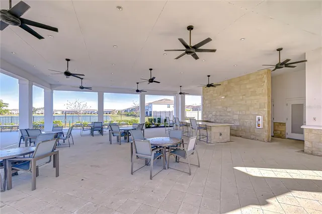 a view of a swimming pool with outdoor seating and plants