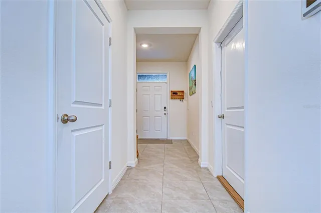 a view of a hallway with wooden shelves