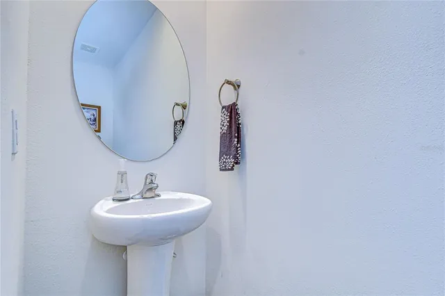 a kitchen with stainless steel appliances granite countertop a sink a stove a refrigerator cabinets and chairs