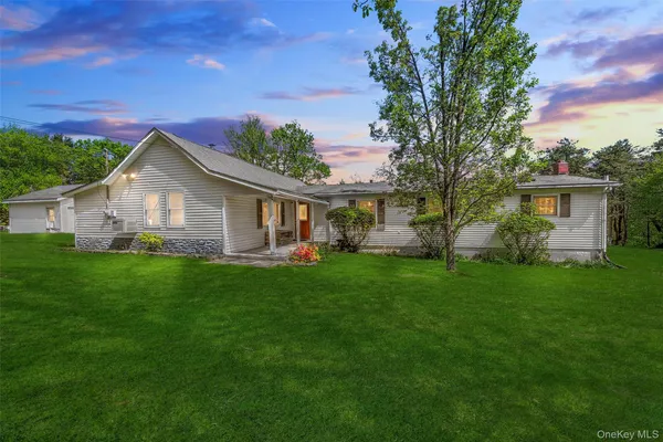 a front view of house with yard and green space
