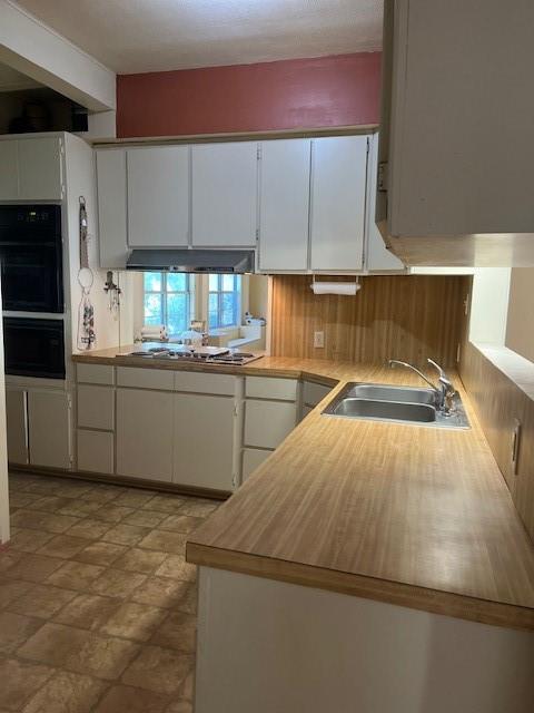 248 South Jacobs Street Albany, TX 76430 - Photo 5 of 17 Kitchen featuring white cabinets, and built in oven, microwave and cooktop.