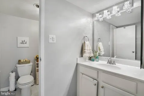 a bathroom with a sink a toilet and a mirror