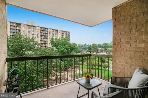 a view of a balcony with chair and wooden floor