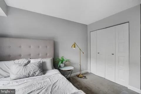 a bedroom with a bed and a potted plant