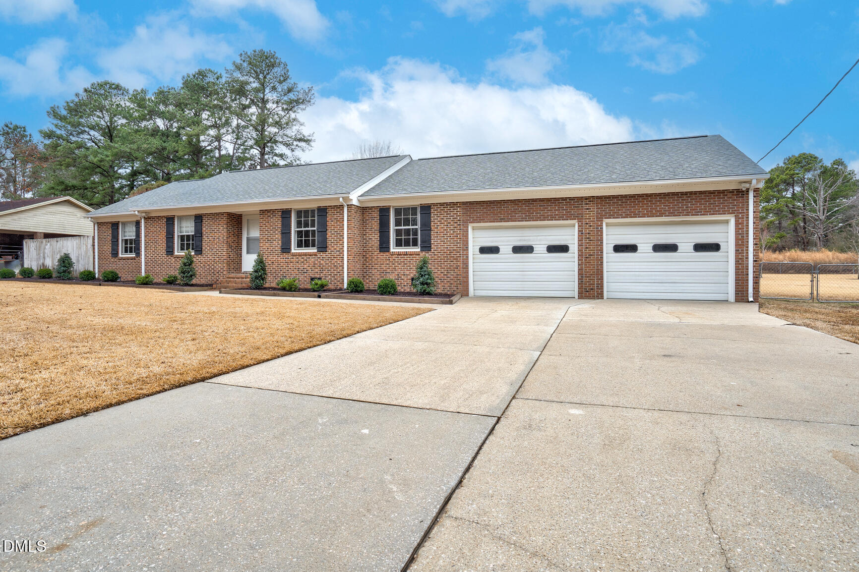 4712 Crest Road Wilson, NC 27893 - Photo 1 of 31 a front view of a house with a yard and garage