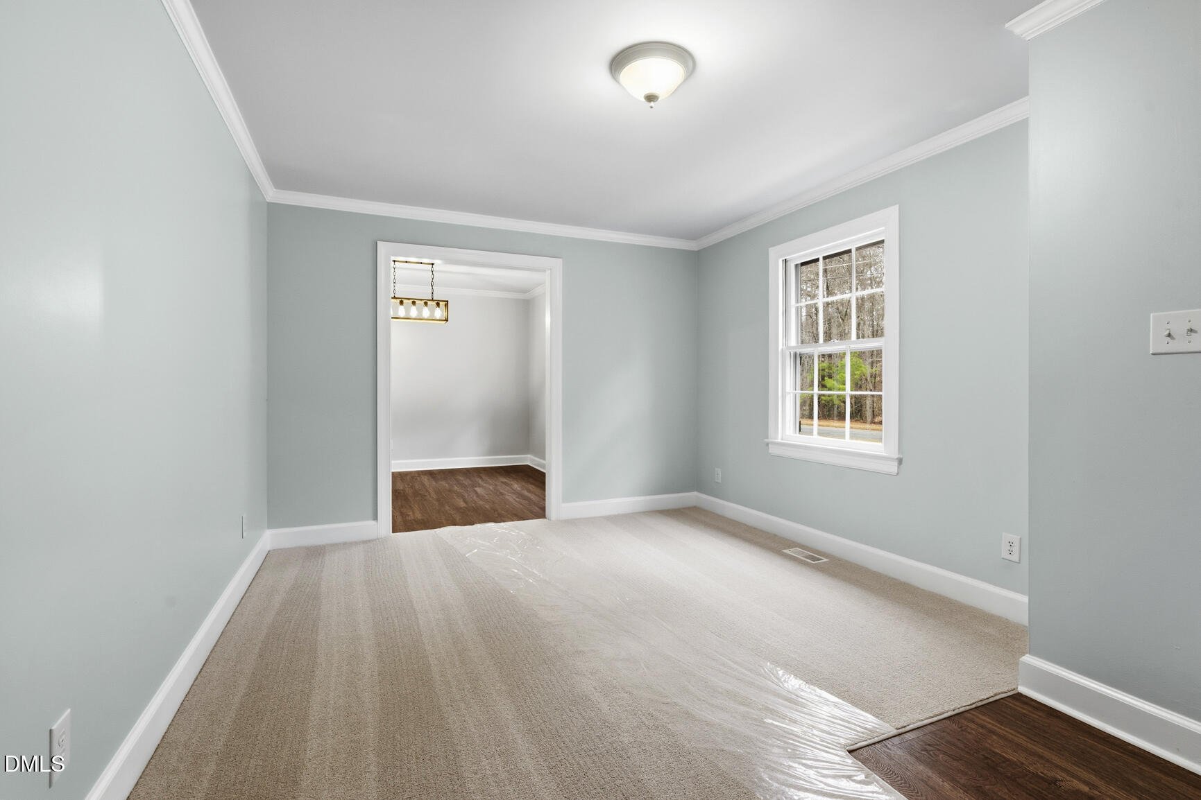 4712 Crest Road Wilson, NC 27893 - Photo 5 of 31 an empty room with wooden floor cabinet and windows