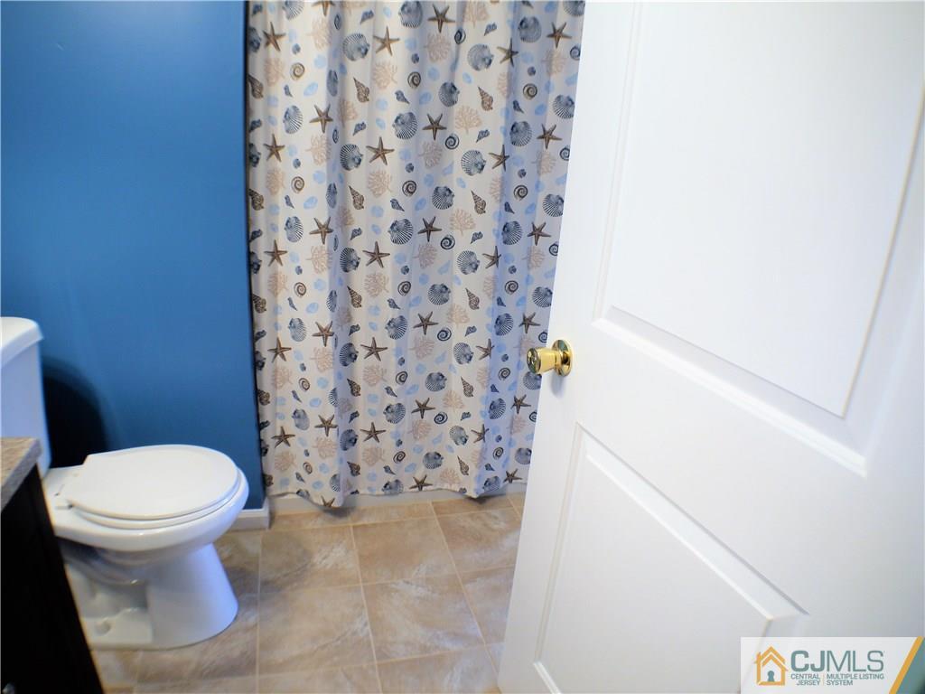 936 Edpas Road, Unit 936 New Brunswick, NJ 08901 - Photo 11 of 21 a bathroom with a toilet and a shower curtain