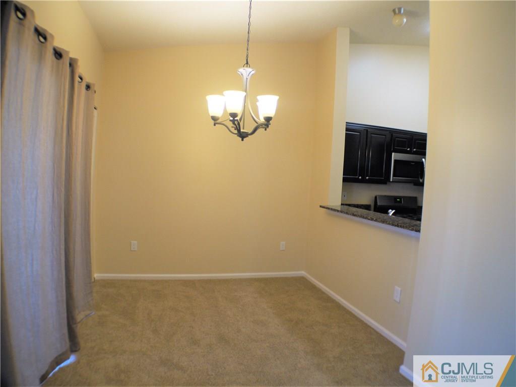 936 Edpas Road, Unit 936 New Brunswick, NJ 08901 - Photo 14 of 21 a view of a livingroom with a chandelier
