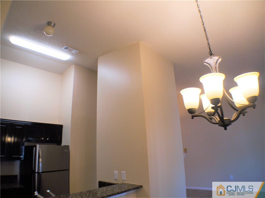 936 Edpas Road, Unit 936 New Brunswick, NJ 08901 - Photo 16 of 21 a view of a hallway with wooden floor