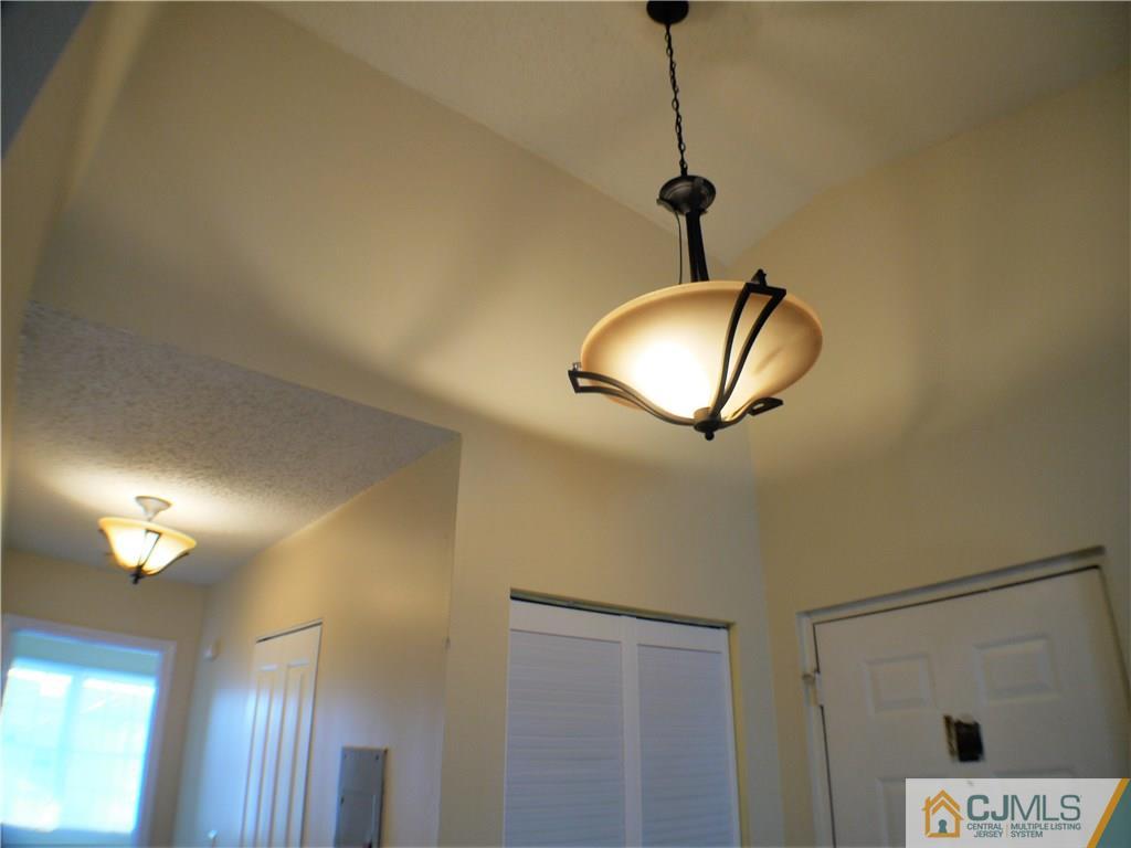 936 Edpas Road, Unit 936 New Brunswick, NJ 08901 - Photo 17 of 21 a view of a room with a chandelier fan