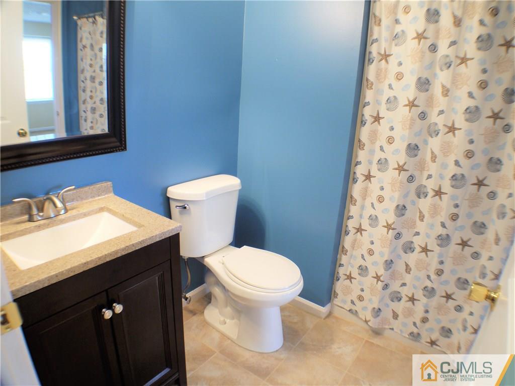 936 Edpas Road, Unit 936 New Brunswick, NJ 08901 - Photo 9 of 21 a bathroom with a sink and a toilet