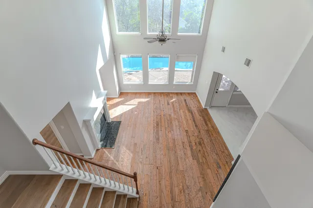 a view of a hallway with wooden floor and entryway