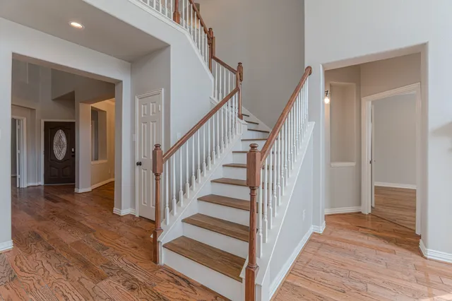 a view of entryway and hall with wooden floor