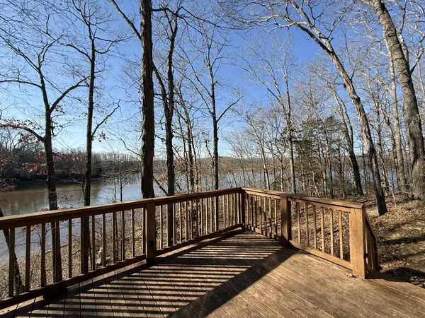 a view of balcony with wooden floor and fence