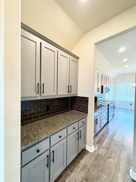 293 Cisco Trail Forney, TX 75126 - Photo 12 of 19 a kitchen with granite countertop a sink and cabinets