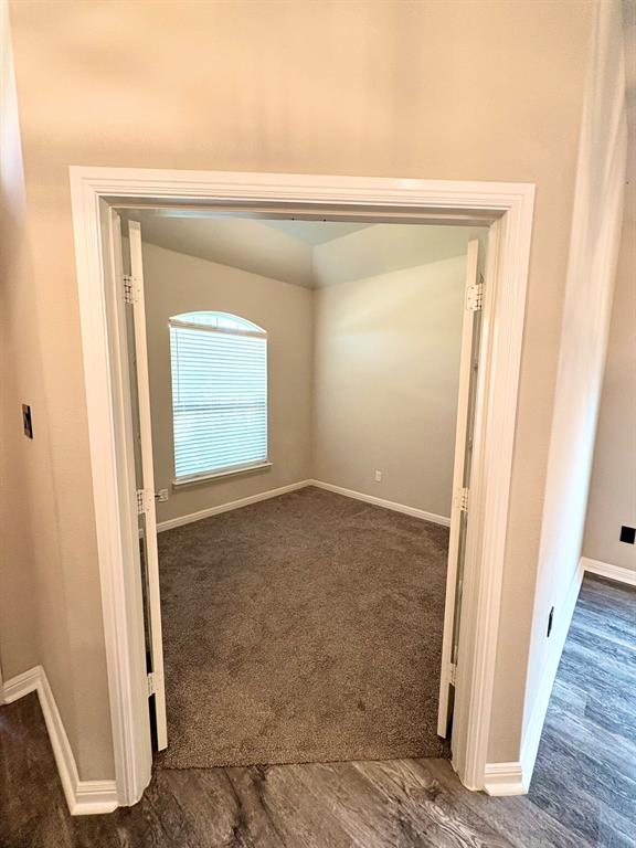 293 Cisco Trail Forney, TX 75126 - Photo 14 of 19 a view of an empty room with wooden floor and a window