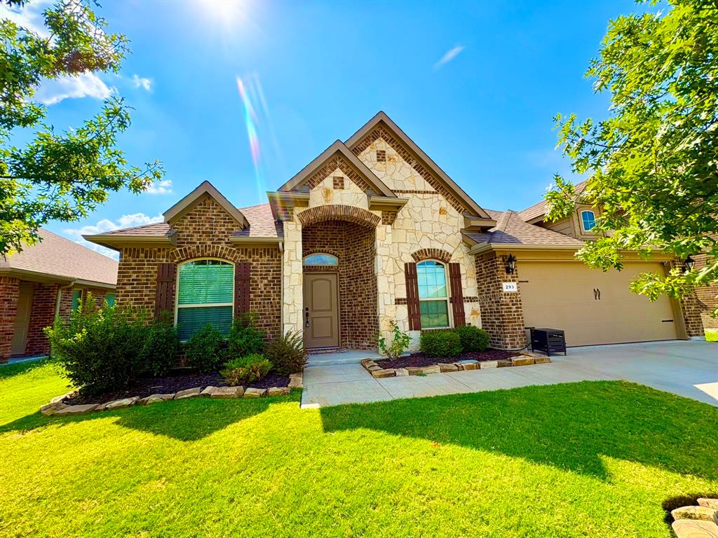 293 Cisco Trail Forney, TX 75126 - Photo 2 of 19 a front view of a house with a yard and garage