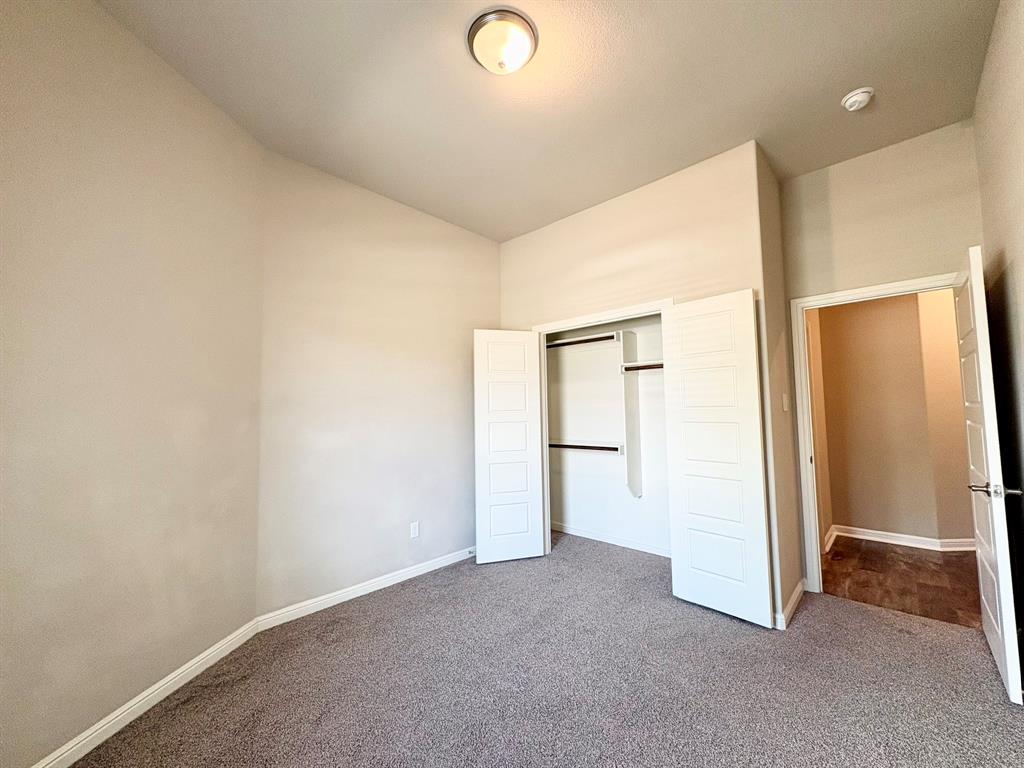 293 Cisco Trail Forney, TX 75126 - Photo 5 of 19 an empty room with closet and mirror