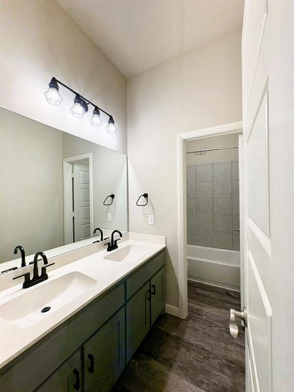 293 Cisco Trail Forney, TX 75126 - Photo 8 of 19 a bathroom with a double vanity sink a mirror and a bathtub