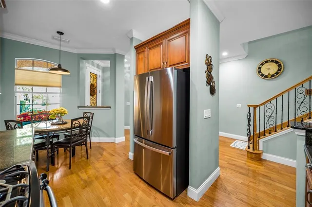 a large kitchen with stainless steel appliances granite countertop a stove and a sink