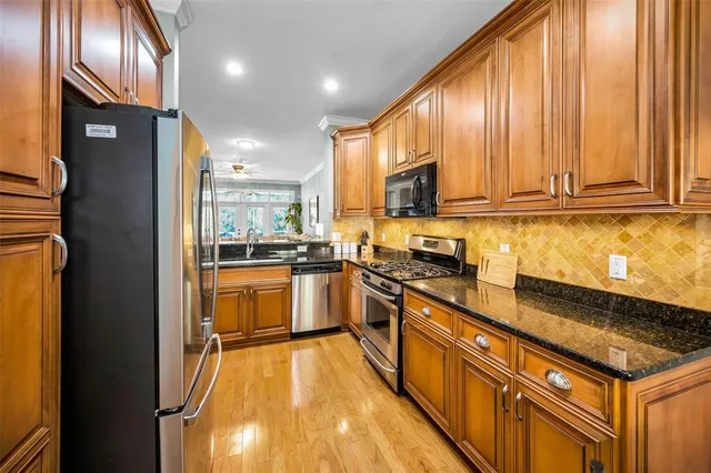 a en suite bathroom with a granite countertop sink and a mirror