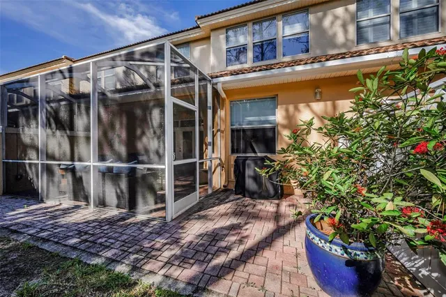 a view of a backyard with potted plants and a bench