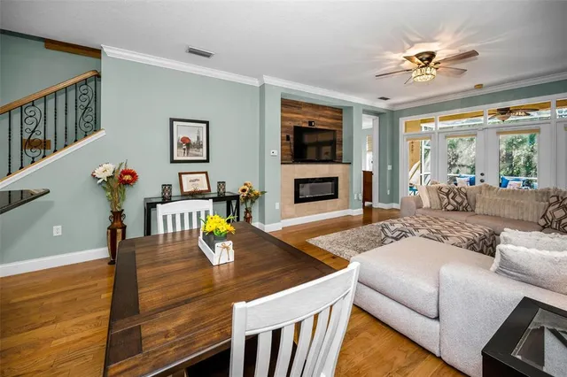 a living room with furniture a flat screen tv and a fireplace