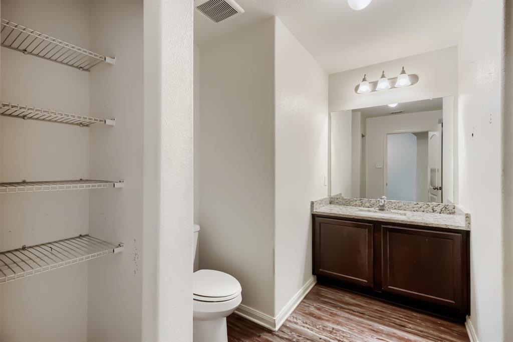 4309 Cat Tail Way Forney, TX 75126 - Photo 25 of 30 Second Bathroom with vanity featuring a granite-style countertop, dark wood-finish cabinetry, and a rectangular mirror