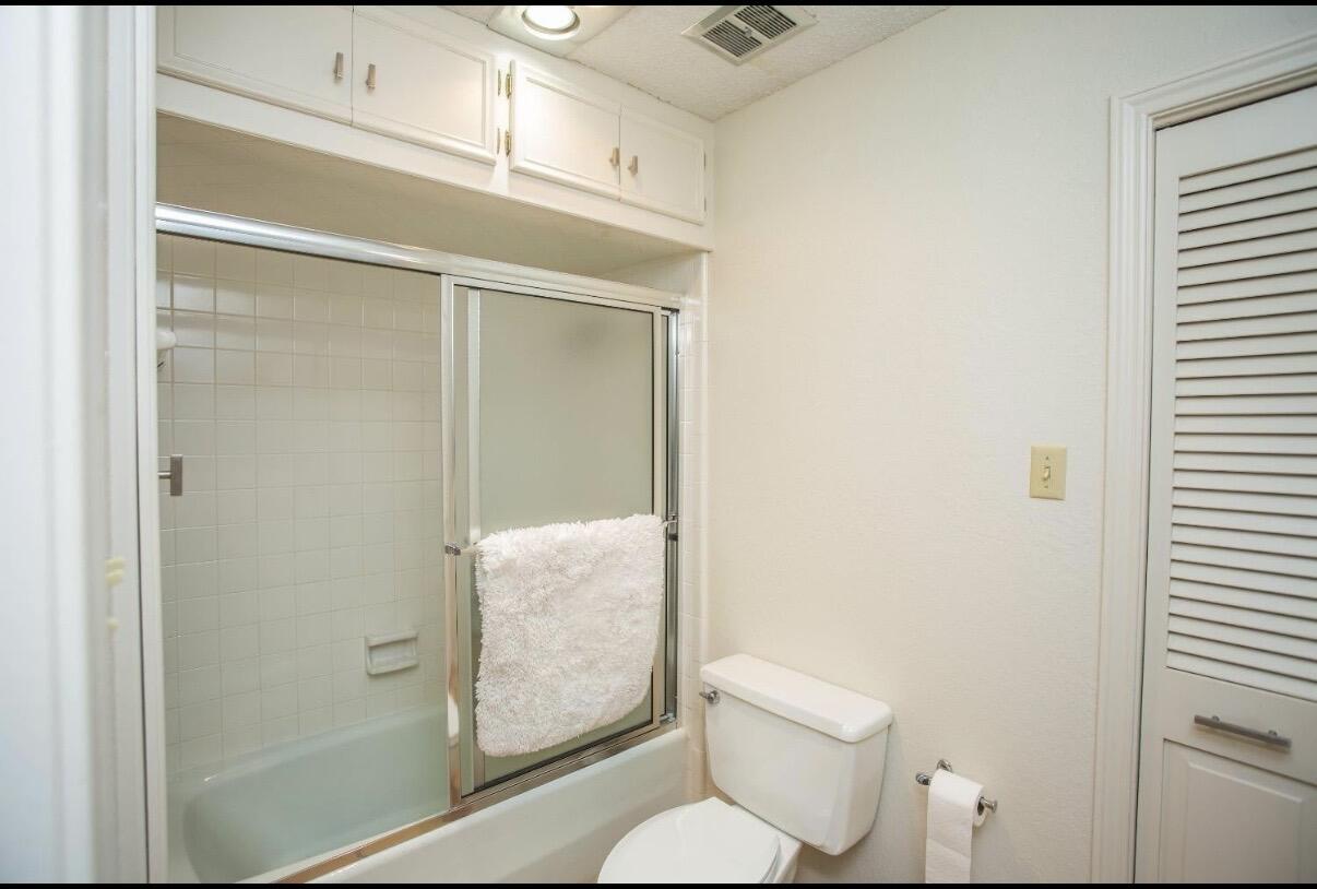 5202 20th Street Lubbock, TX 79407 - Photo 21 of 45 a bathroom with a toilet and a shower