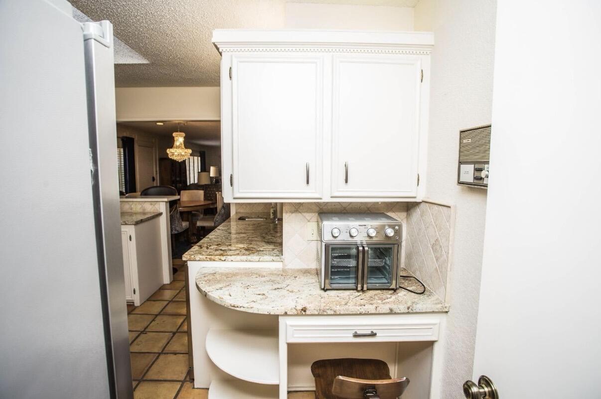 5202 20th Street Lubbock, TX 79407 - Photo 27 of 45 a kitchen with a sink and a refrigerator