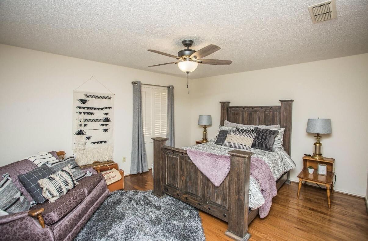 5202 20th Street Lubbock, TX 79407 - Photo 29 of 45 a bed room with a bed and a couch